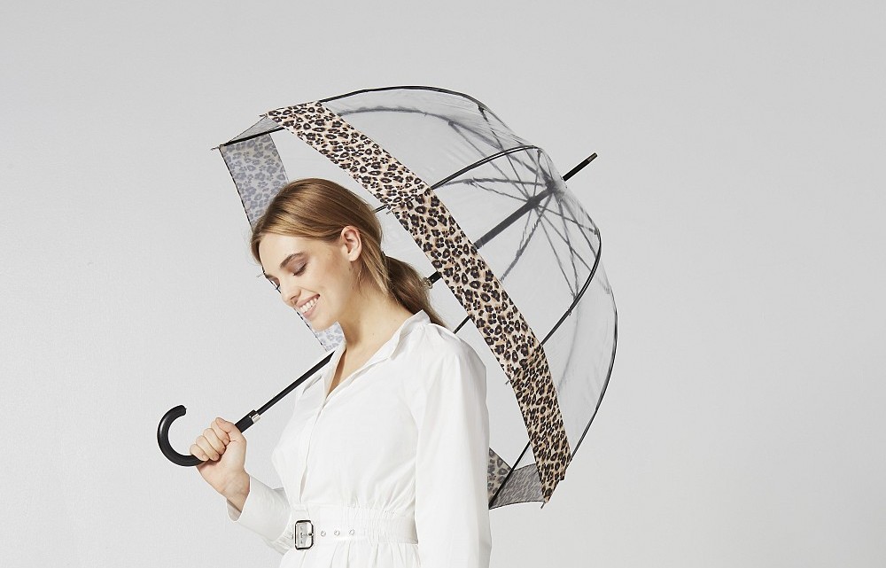 Woman holding the Fulton Birdcage Luxe Natural Leopard Umbrella